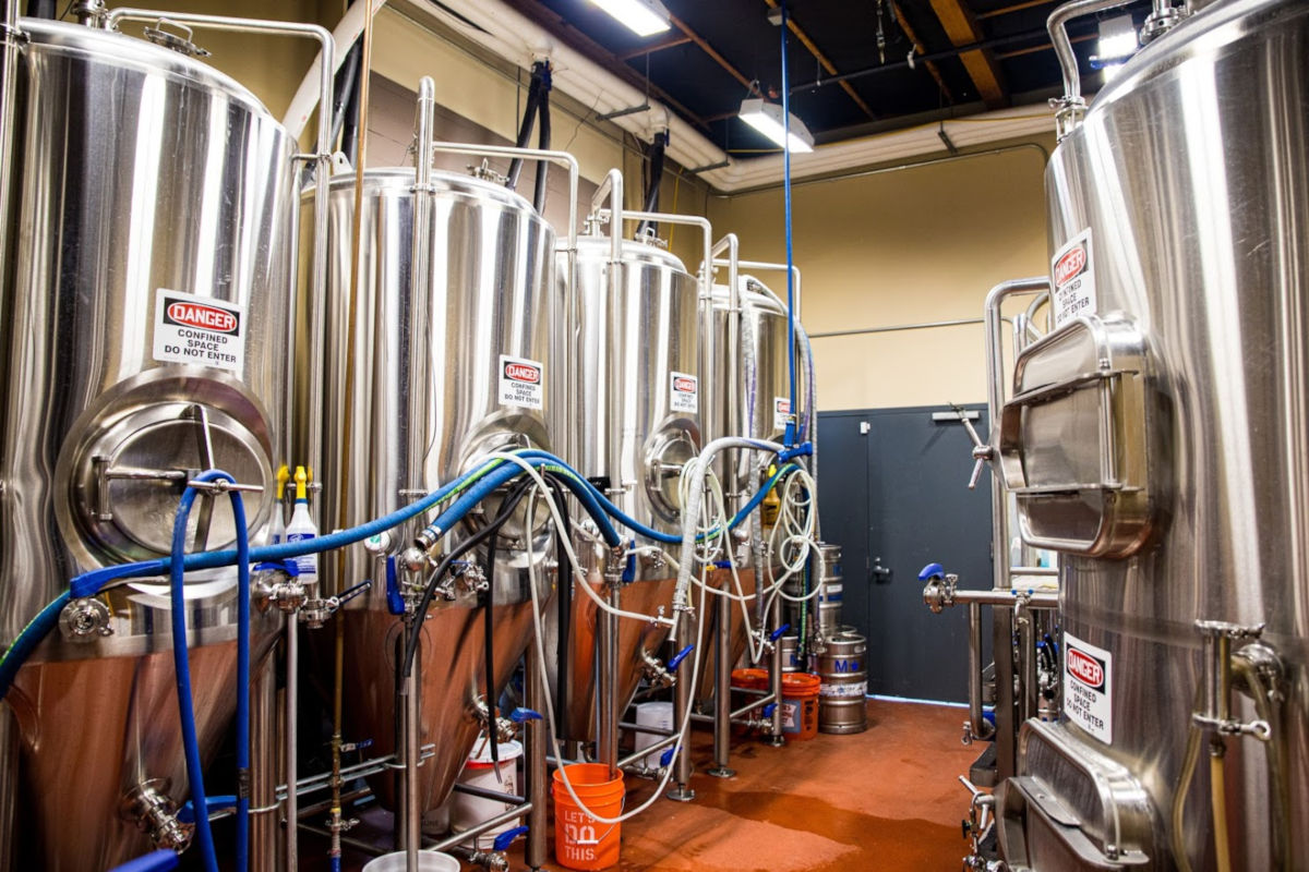 Interior, brewing area with metal canisters and piping